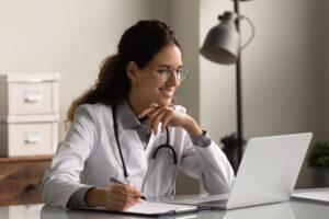 smiling doctor on laptop