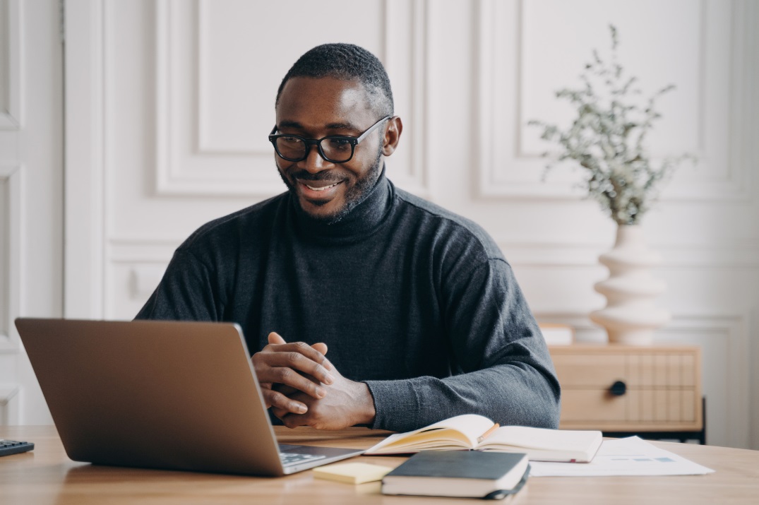 A remote doctor participating in a video call from a home office, collaborating with patients or healthcare professionals.