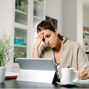 Woman sitting exasperated at her computer